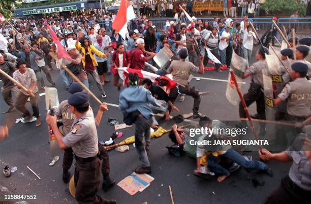 Indonesian soldiers beat back university students with rattan sticks after the students tried to push through a blockade to march to parliament in...