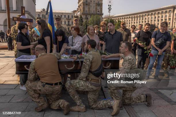 Relatives and friends mourn over the coffin of Ivan Shulha, a Ukrainian serviceman, who was killed fighting Russian troops in the Donetsk region, at...