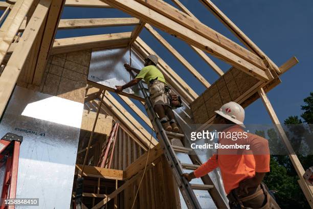 Workers build homes in Lillington, North Carolina, US, on Thursday, June 15, 2023. The US Census Bureau is scheduled to release housing starts...