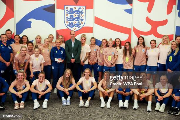 Prince William, Prince of Wales and President of The Football Association, poses with the England team during a visit to England Women's team to wish...
