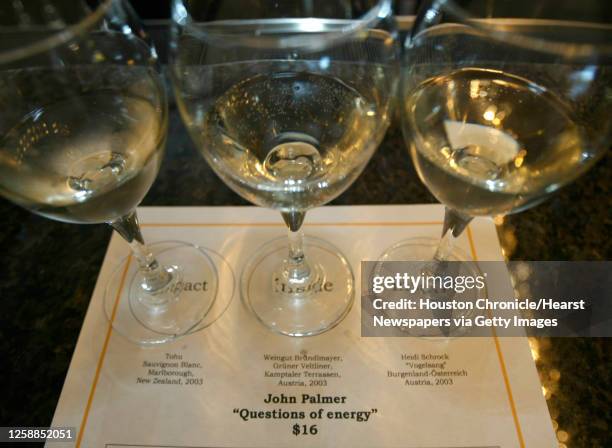 Three different white wines sit on a placemat at the bar during a bimonthly series that Patrick Davila is running at the Sam Houston Hotel, where he...