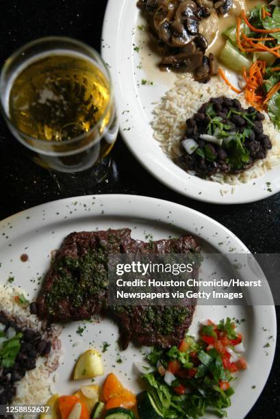 Bar menu items Carne Asada, bottom plate, and the top plate is Pollo Marsala, which was shot at Fernando's Latin Cuisine, 14135 Southwest Freeway,...