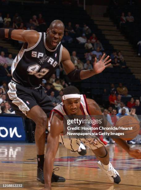 Houston's, Eddie Griffin gets tripped up by San Antonio's, Kevin Willis in the 3rd quarter action, during the Houston Rockets-San Antonio Spurs...