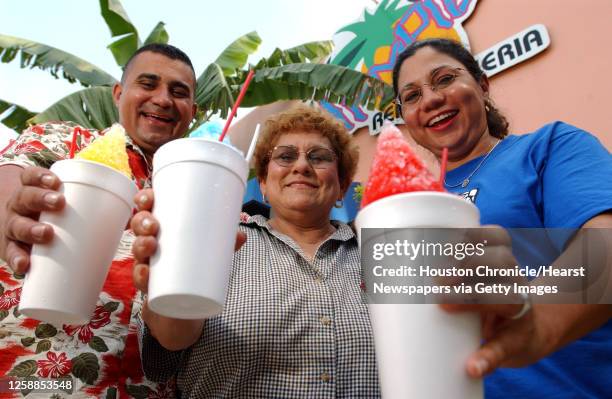 Tampico Refresqueria co-owners siblings Omar and Janie Narvaez, and their mother, Amparo , hold their raspas, which are Mexican snow cones at...