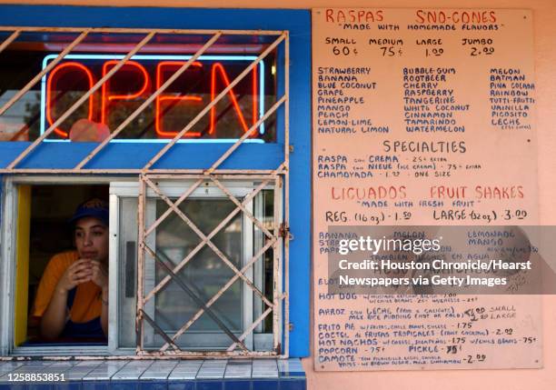 Janeth Rojo, waits for customers as she serves raspas, Mexican snow cones, at Tampico Refresqueria, Thursday afternoon, at the 7525 Irvington...