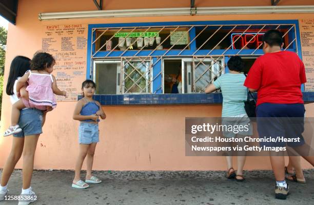 Crowds gather to order their raspas, which are Mexican snow cones, at Tampico Refresqueria, Thursday afternoon, at the 7525 Irvington location....