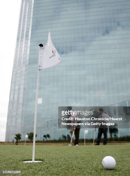 David Pearson, left, and Kenny Woods, right play on the rooftop Jack Nicklaus-designed putting green atop Phoenix Tower, which is a skyscraper in the...