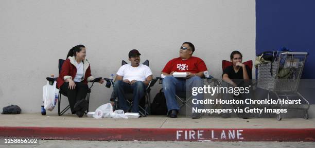 Eager PlayStation 3 buyers sit in line at the Best Buy at 5133 Richmond Ave, Tuesday, November 14 where the chaotic battle to buy a new PlayStation 3...