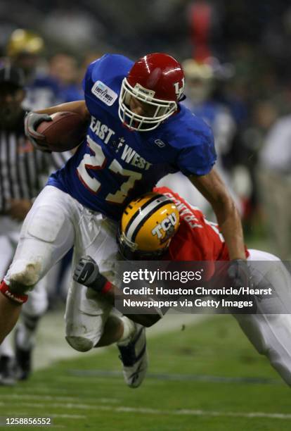 West's, Jackie Battle, of the University of Houston gets tackled near the endzone by East's, Daniel Francis during the 2nd quarter of the Dell...