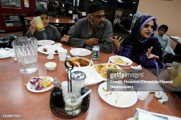 Heena Aslam, far right, and her husband, Mohammad, and son, Taha Aslam share a meal together after sunset as they celebrate Ramadan at the Savoy...