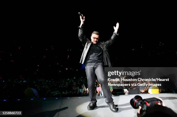 Bono finishes a song at the U2 concert at Reliant Stadium, Wednesday, Oct. 14 in Houston.