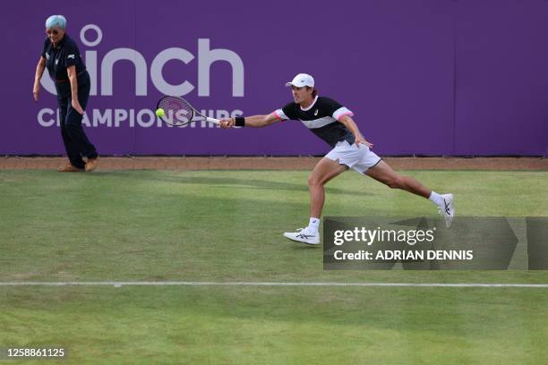 Australia's Alex de Minaur stretches to return against Britain's Andy Murray during their men's singles round of 32 tennis match on Day 4 of the...