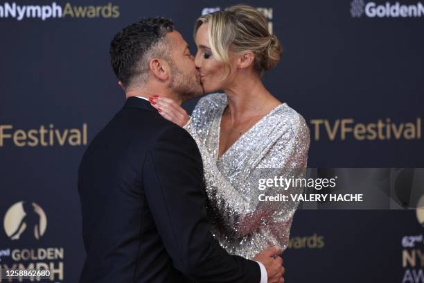 British actor Warren Brown kisses British journalist Anna Woolhouse during a photocall for the Golden Nymph Awards ceremony of the 62nd Monte-Carlo...