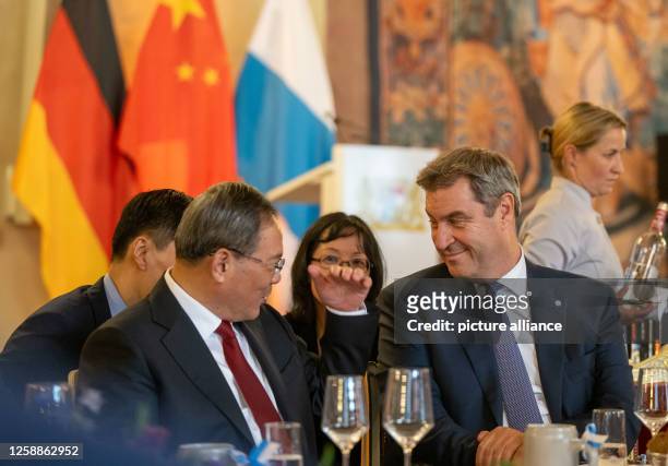 June 2023, Bavaria, Munich: China's Premier Li Qiang talks with Markus Söder, Prime Minister of Bavaria, during a dinner at the Munich Residence....