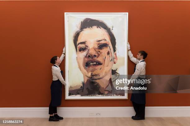 Gallery staff members hold a painting titled âShadow Studyâ by Jenny Saville during a photocall at Sotheby's auction house showcasing the highlights...