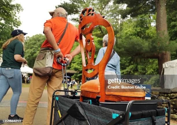 Sturbridge, MA A man pulls an antique chair in a cart at Sturbridge Village for an episode of the Antiques Roadshow TV show.