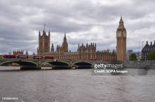 General view of the Houses of Parliament, River Thames and Westminster Bridge on a cloudy day.