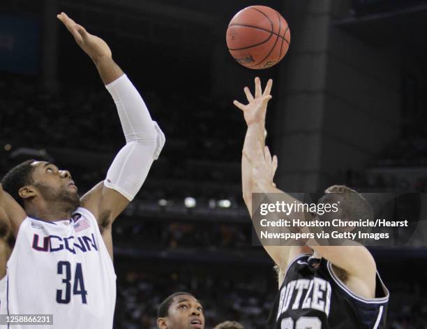 Butler guard Chase Stigall tries to shoot over Connecticut center Alex Oriakhi during the first half of the NCAA National Championship at Reliant...