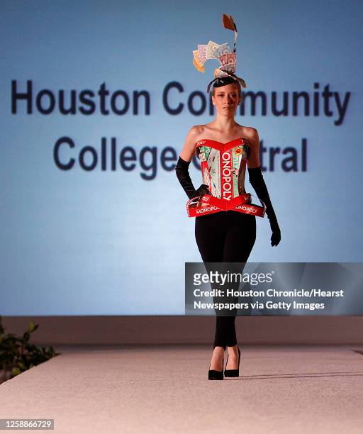 Model walks the runway wearing a Monopoly box and money that was made from recycled materials in a segment they call "Flash and Trash" by an unknown...