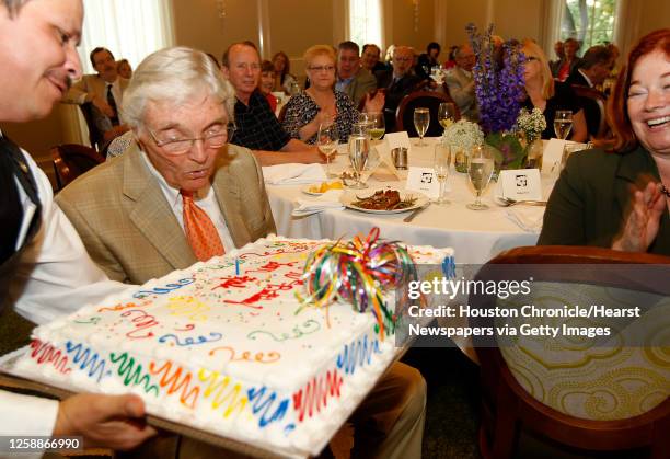 Leon Hale blows out the candle on his birthday cake during his 90th birthday luncheon at Brennan's, Tuesday, May 31, 2011.