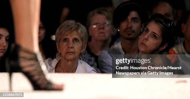 Louise Fisher, left, and Amy Pinkerton watch a model walk the runway during the Houston Community College-Central's student fashion show at the third...