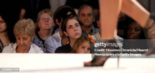 Louise Fisher, left, and Amy Pinkerton watch a model walk the runway during the Houston Community College-Central's student fashion show at the third...