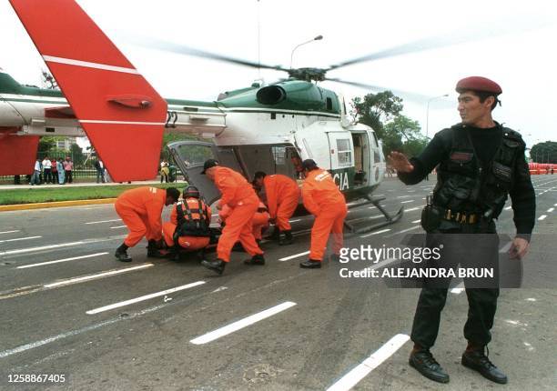 Police conduct a mock trial of a rescue, in the case of an earthquake, Lima, Peru, 11 October 1999. Un policia controla el paso de los periodistas...