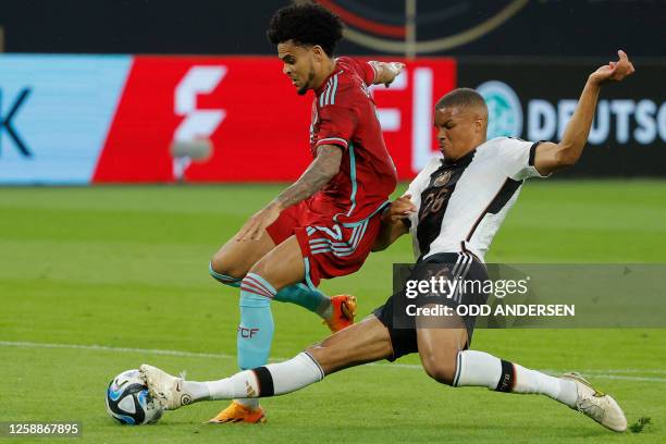 Germany's defender Malick Thiaw gets the ball off Colombia's forward Luis Diaz during the international friendly football match between Germany and...