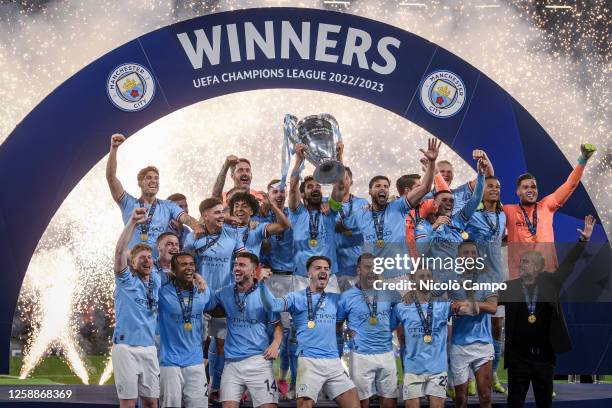 Ilkay Gundogan of Manchester City FC lifts the trophy as the teammates celebrate during the award ceremony following the UEFA Champions League final...