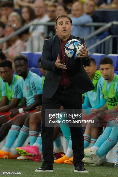 Colombia's Argentine coach Nestor Lorenzo catches the ball on the sidelines during the international friendly football match between Germany and...