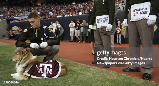 Texas A&M cadet Ryan Crawford, a sophmore, takes care of the A&M mascot, REveille VIII, before the start of the Meineke Car Care Bowl at Reliant...