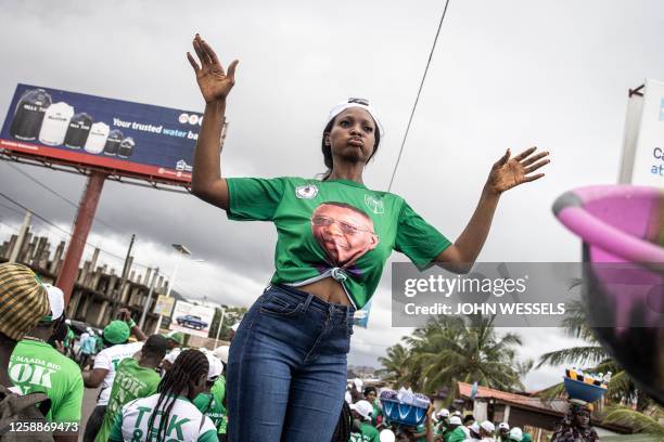 Supporter of the President of Sierra Leone and Leader of Sierra Leone People's party , Julius Maada Bio, dances during their final campaign rally in...