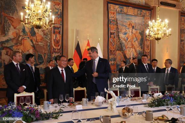 State Premier of Bavaria Markus Soeder and Chinese Premier Li Qiang arrive at the festive dinner in the Kaisersaal of Munich Residence on June 20,...