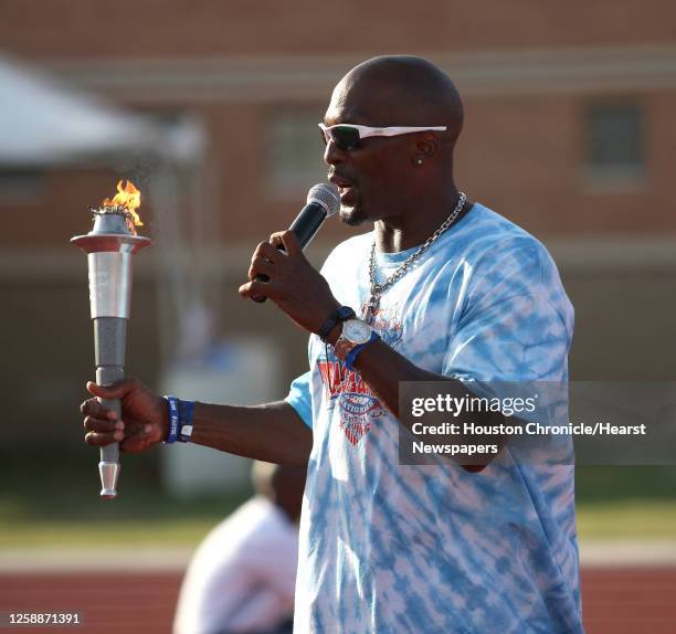Darnell Hall, of Detroit, holds the Junior Olympic torch as he ceremonially takes it on it's journey to Detroit for the next Junior Olympics during...