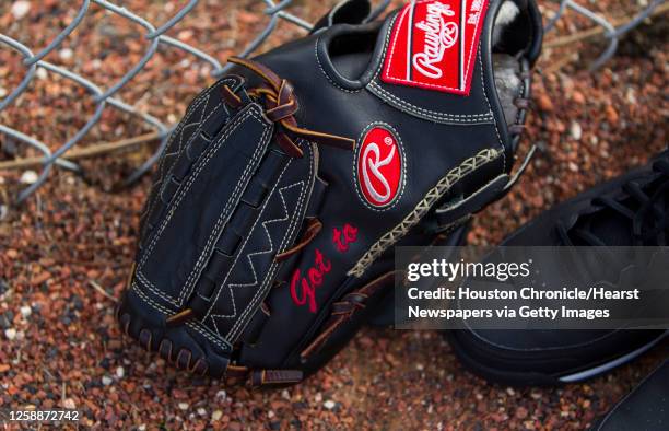 Player's glove with "Got to" embroidered on it in the warning track at the Oseola County Stadium, Tuesday, Feb. 12 in Kissimmee, as pitchers and...