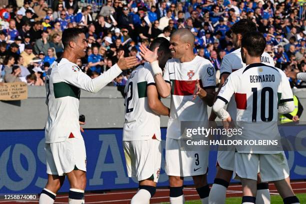 Portugal's forward Cristiano Ronaldo celebrates with teammates after scoring the 0-1 goal during the UEFA Euro 2024 group J qualification football...