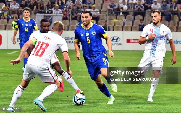 Bosnia's Sead Kolasinac runs with the ball during the UEFA Euro 2024 group J qualifier football match between Bosnia and Herzegovina and Luxembourg...