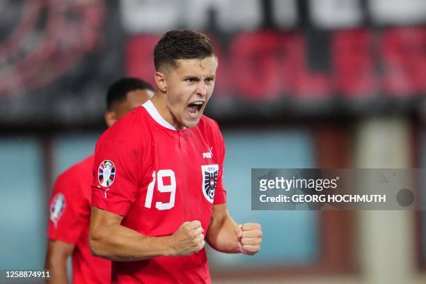 Austria's midfielder Christoph Baumgartner celebrates his 1-0 during the UEFA Euro 2024 group F qualification football match between Austria and...