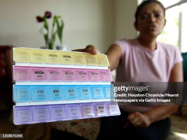 Raquel Forzeska holds up a pill case as she speaks in her unlicensed group home "Home of Dignity," Gupta's death remained under invesitigation as of...