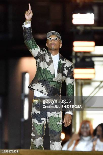 Louis Vuitton' fashion designer and singer Pharrell Williams acknowledges the audience at the end of the Louis Vuitton Menswear Spring-Summer 2024...