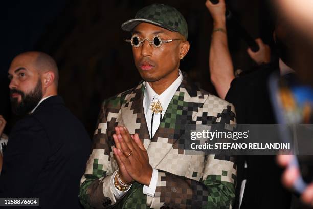 Louis Vuitton' fashion designer and singer Pharrell Williams acknowledges the audience at the end of the Louis Vuitton Menswear Spring-Summer 2024...