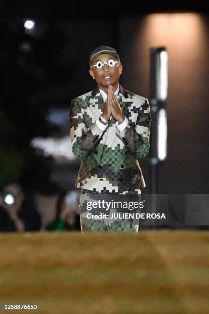 Louis Vuitton' fashion designer and singer Pharrell Williams acknowledges the audience at the end of the Louis Vuitton Menswear Spring-Summer 2024...