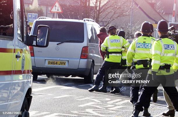 Protesters are grabbed by police as they rush the van carrying 42-year-old Roy Whiting as it leaves Chichester Magistrates court, 07 February 2001....