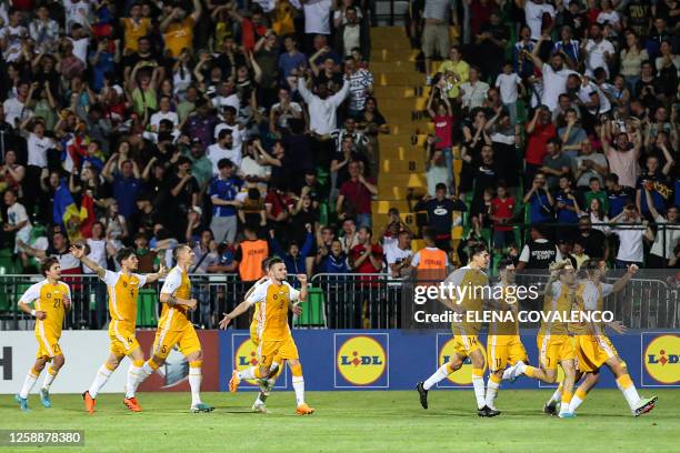 Moldavian players celebrate their team's third goal against Poland during the group E Euro 2024 qualifier football match between Moldova and Poland...