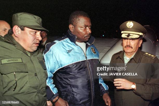 Presumed narcotic trafficker, Columbian Jorge Eliecer Asprilla , alias 'El Campeon," is taken to board an airplane to the United States, by the...