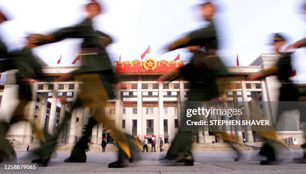 Chinese People's Armed Police march past Beijing's Museum of Revolution, situated next to Tiananmen Square, 29 September 2000, as security around the...