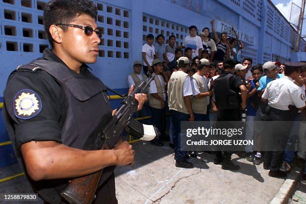 Police officer guards the entrance to the Carlos Salazar Stadium in Mazatenango, 160 km away from Guatemala City, 15 July 2000, moments before the...