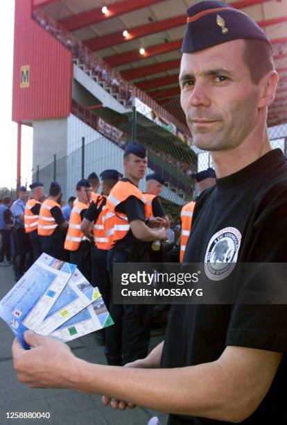 Belgian state policeman shows tickets that were seized before the Euro-2000 soccer match between Germany and Romania, 12 June 2000 in Liège. The...