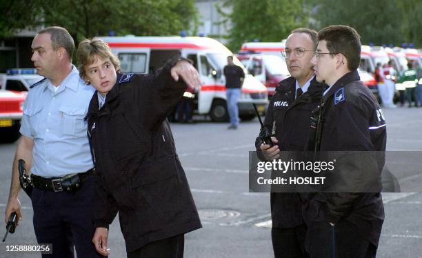 Policemen in front of ambulances secure the area about one kilometer from the day nursery, where a man has taken some children, aged between 4 and 7,...