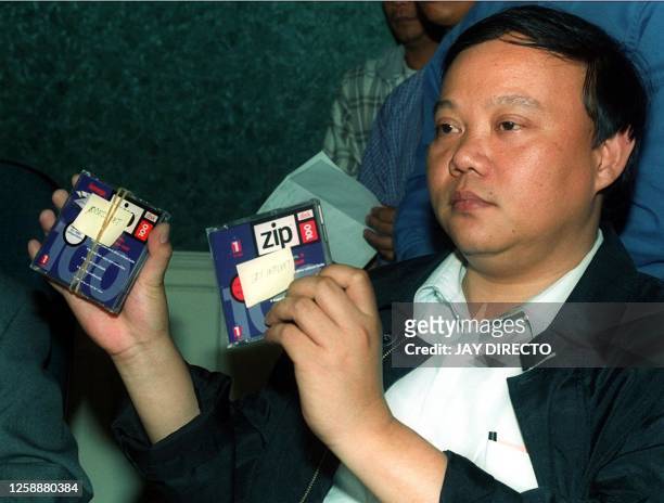 National bureau of Investigation Agent Nelson Bartolome presents to the media 16 May 2000 the diskettes seized from the residence of Philippine...